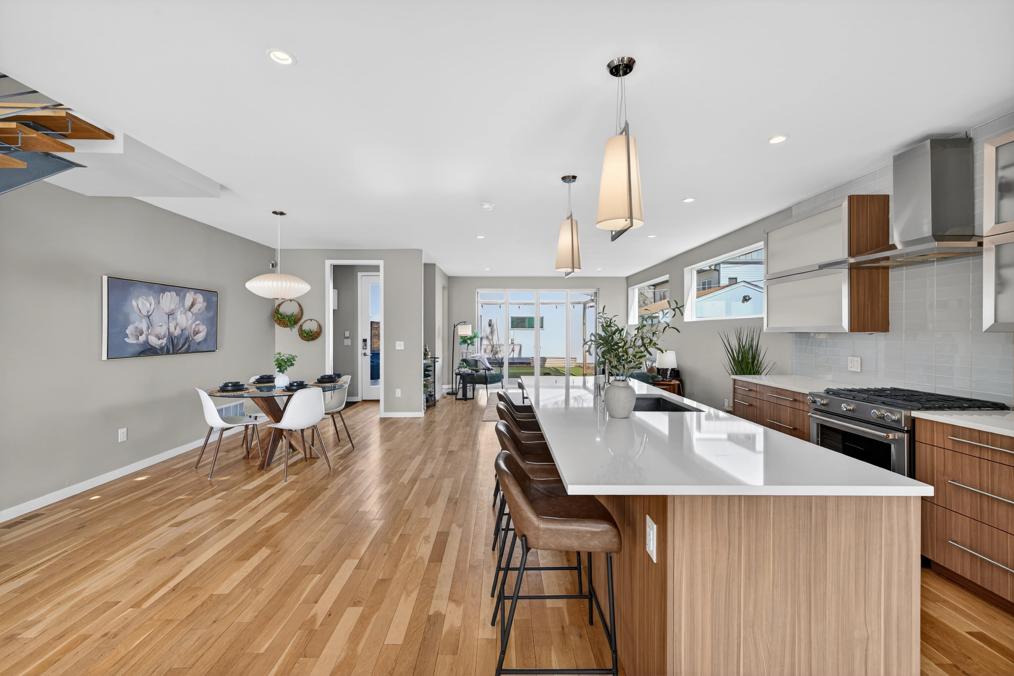 Open floor plan connecting kitchen, dining, and living.